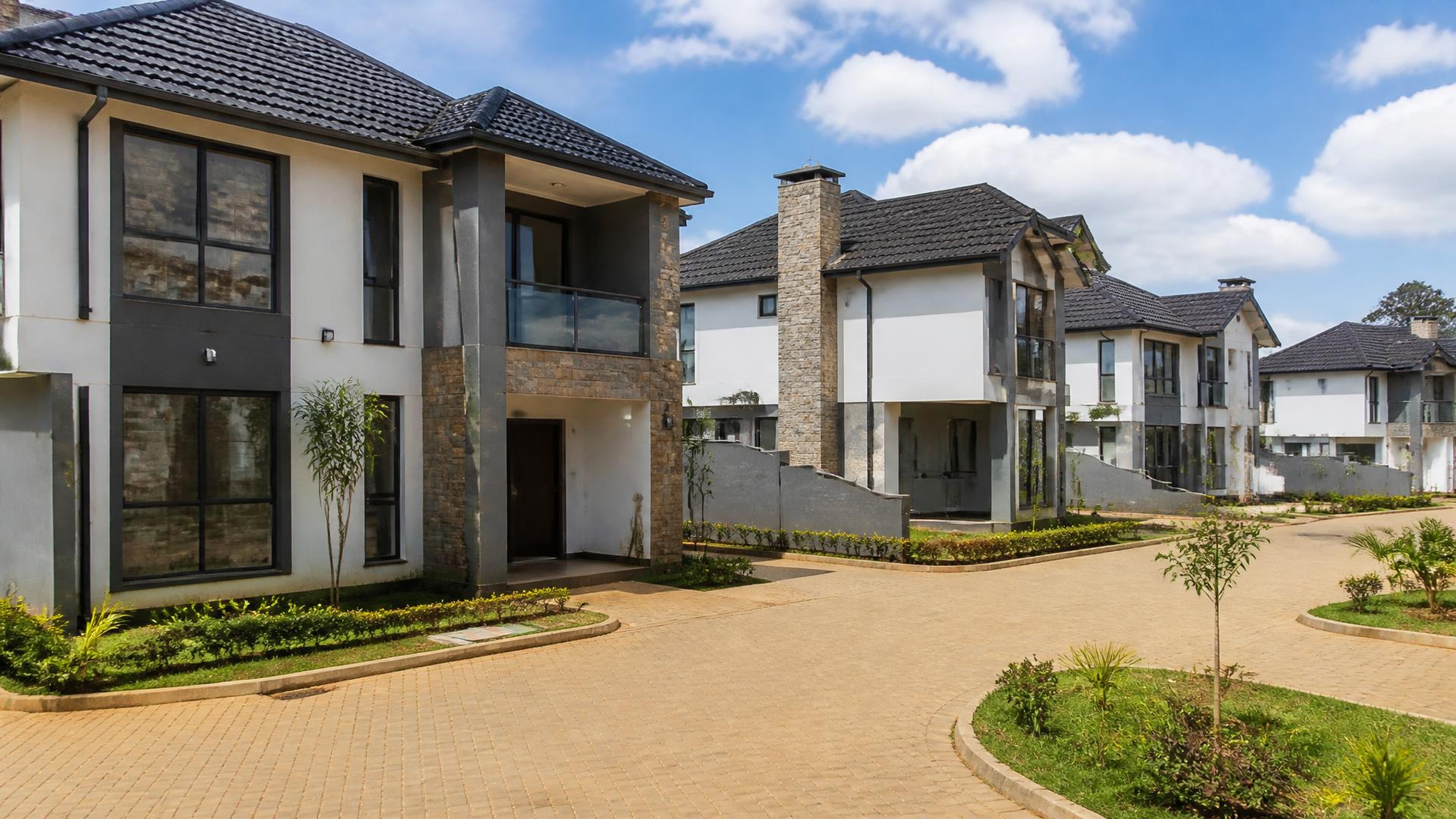 Completed modern gated residential estate with paved internal roads and landscaped family homes