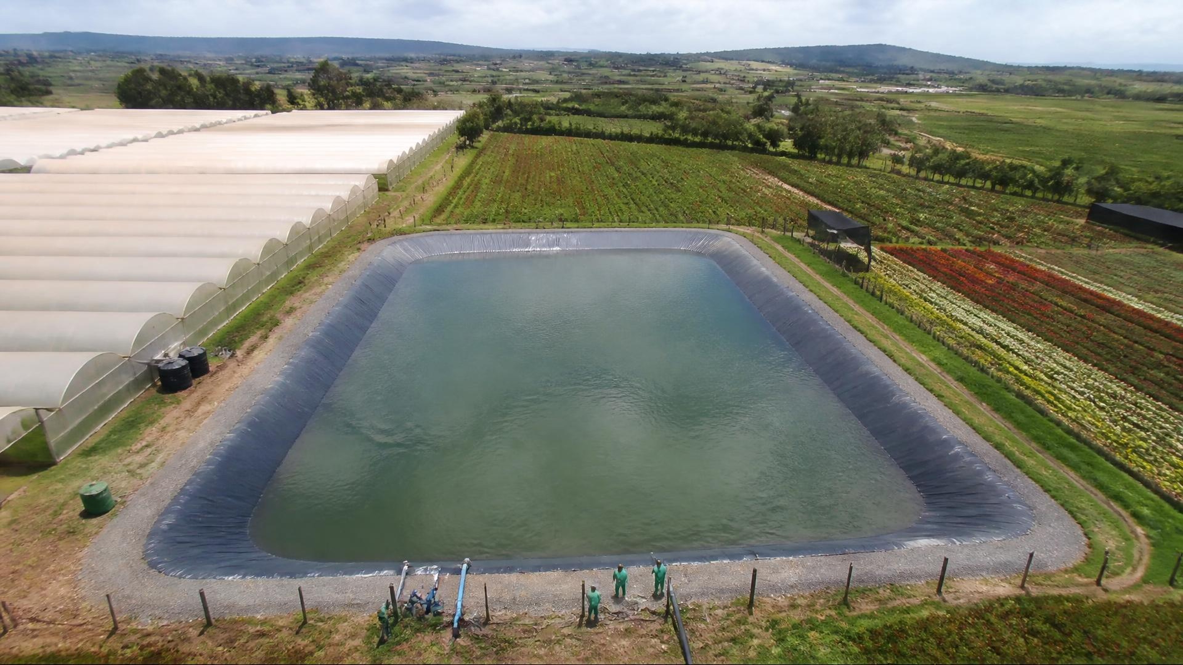 Project-aligned construction imagery for P.J. Dave Flowers Group — 25,000m³ irrigation water pan
