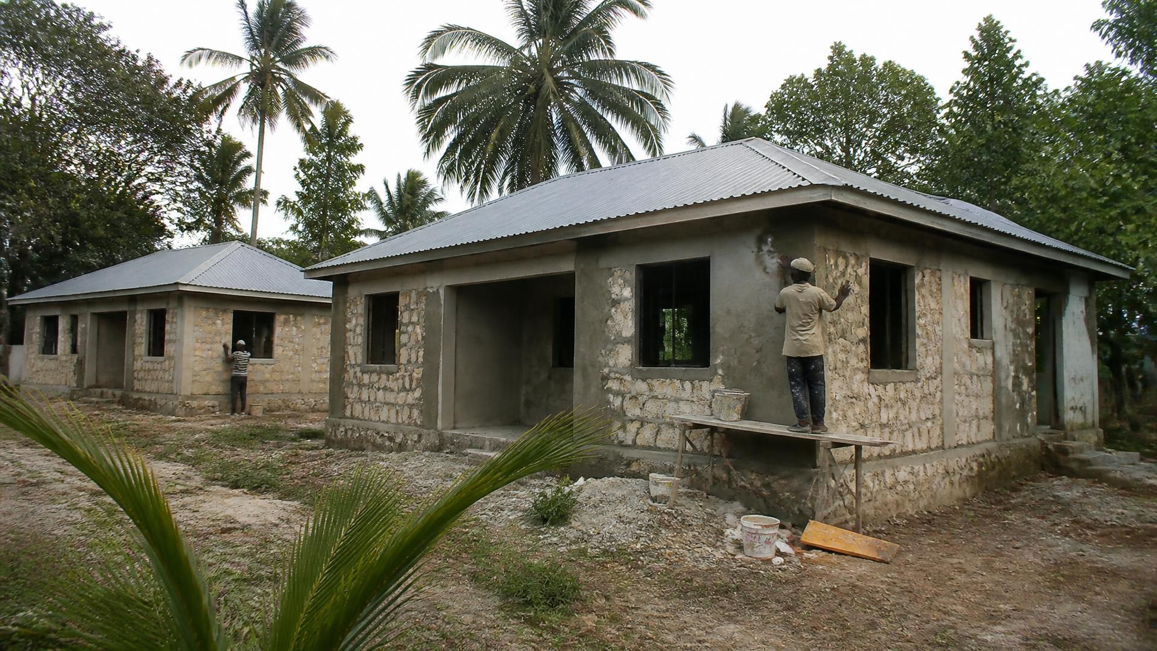 Coastal residential houses receiving exterior finishes in a tropical setting