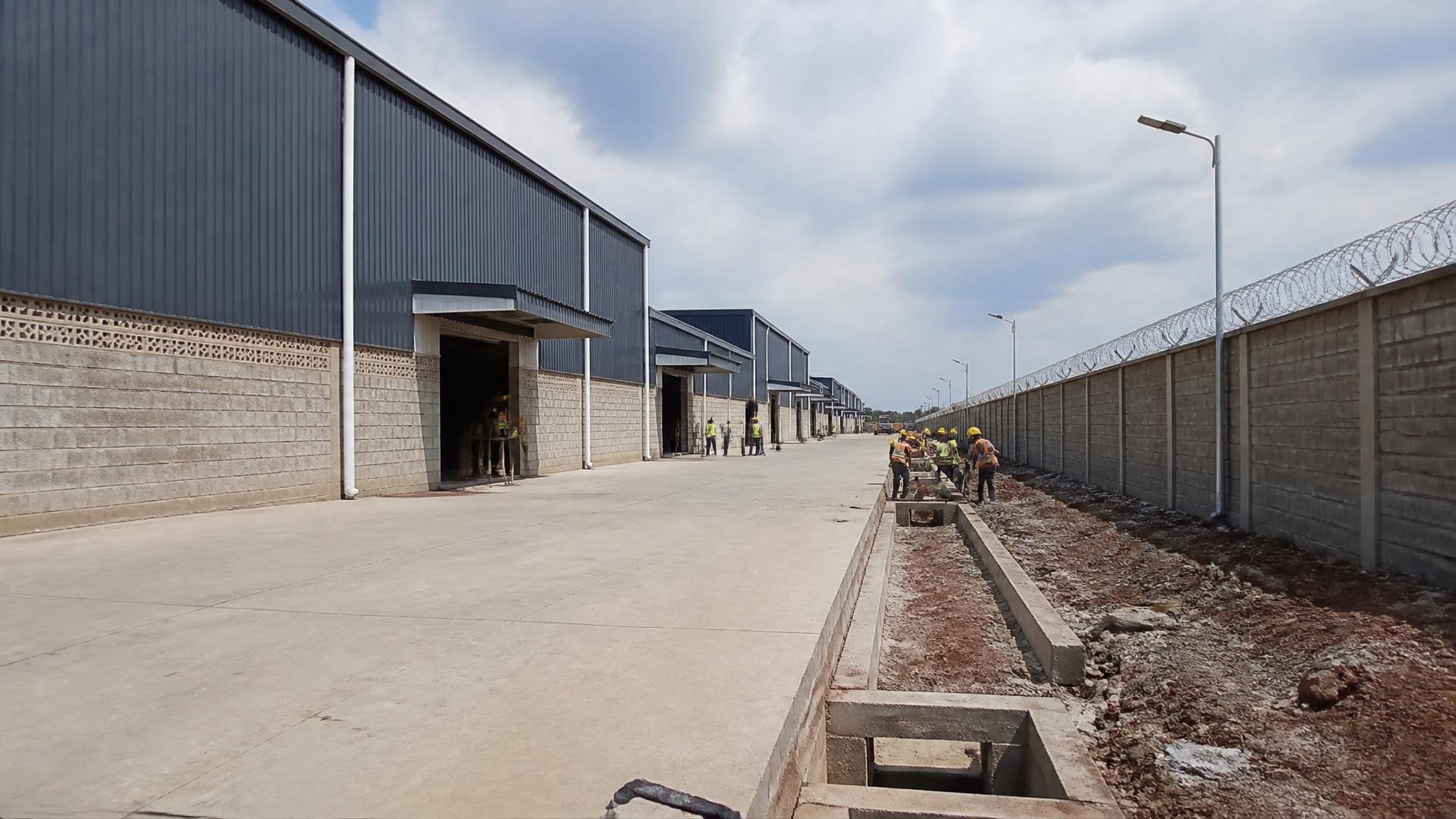 Project-aligned construction imagery for Tunasco Insaat — godowns & perimeter wall, Mombasa Road